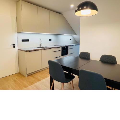 New sunny rooftop apartment with a terrace 10-15 minutes drive from city centre